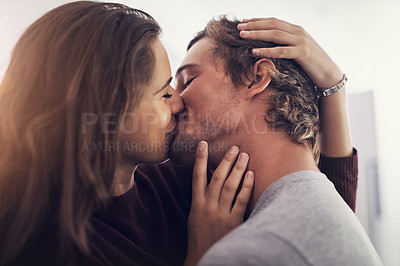 Buy stock photo Shot of a young couple making out in the kitchen