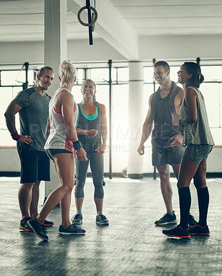 Buy stock photo Shot of a group of young people working out together at the gym