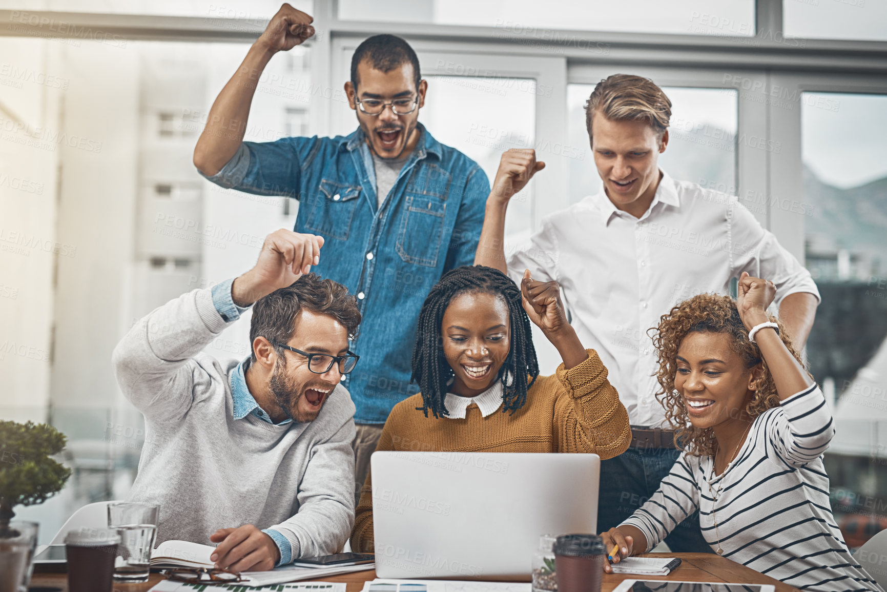 Buy stock photo Shot of colleagues cheering at something on a laptop screen