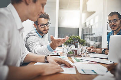 Buy stock photo Shot of colleagues having a discussion in the office