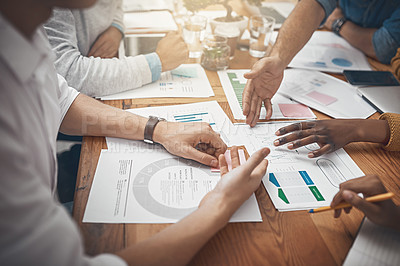 Buy stock photo Shot of a group of businesspeople discussing statistics