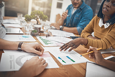 Buy stock photo Shot of a group of businesspeople discussing statistics