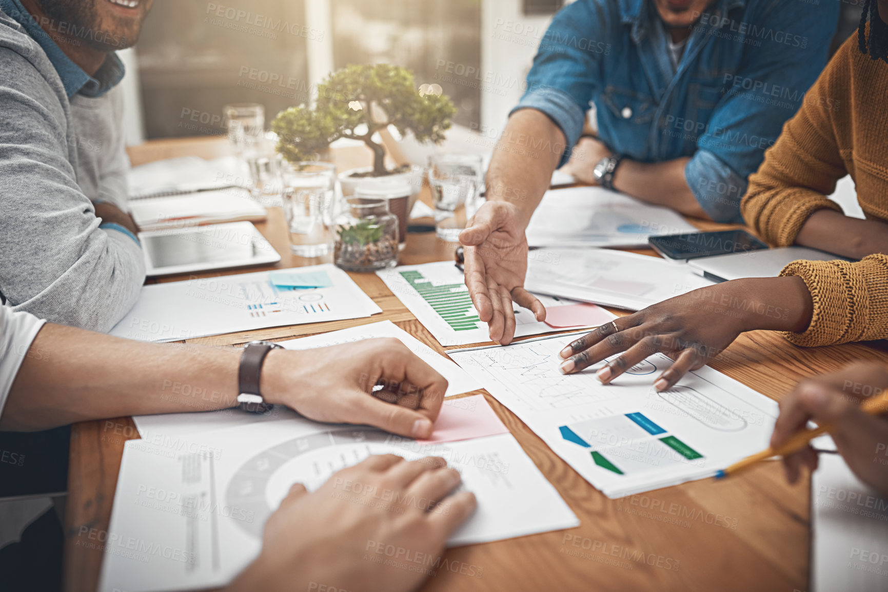 Buy stock photo Shot of a group of businesspeople discussing statistics