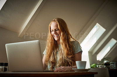 Buy stock photo Shot of a young woman using her laptop in a coffee shop