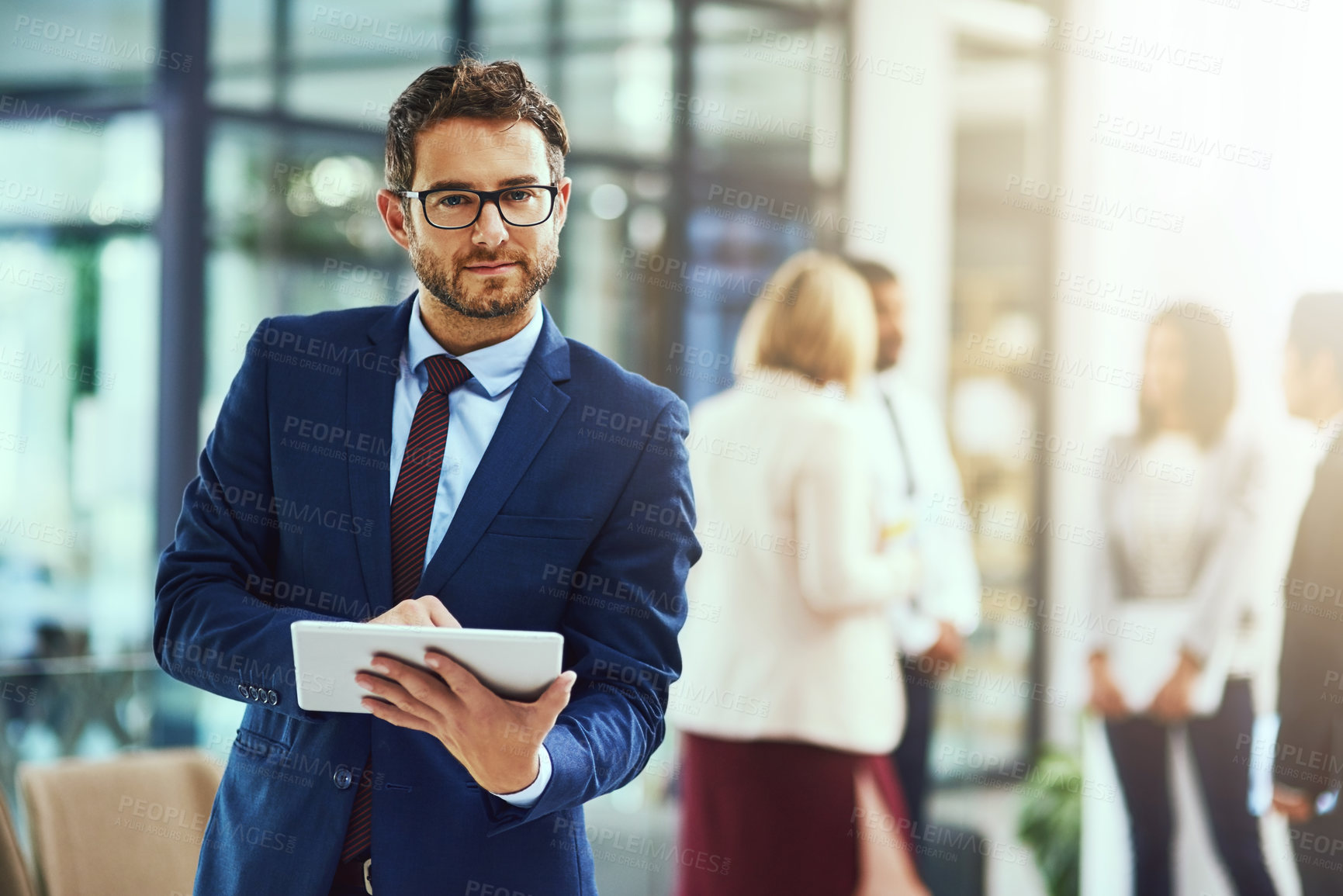 Buy stock photo Portrait of a young businessman using a digital tablet in an office