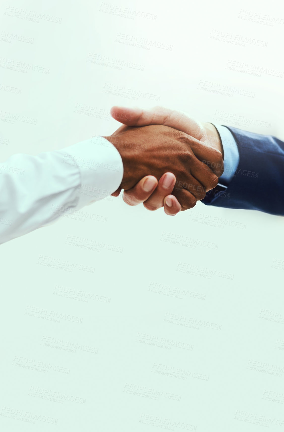 Buy stock photo Shot of two unrecognisable businessmen shaking hands against a white background