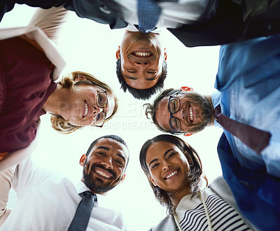 Buy stock photo Portrait of a diverse group of businesspeople putting their heads together in a huddle