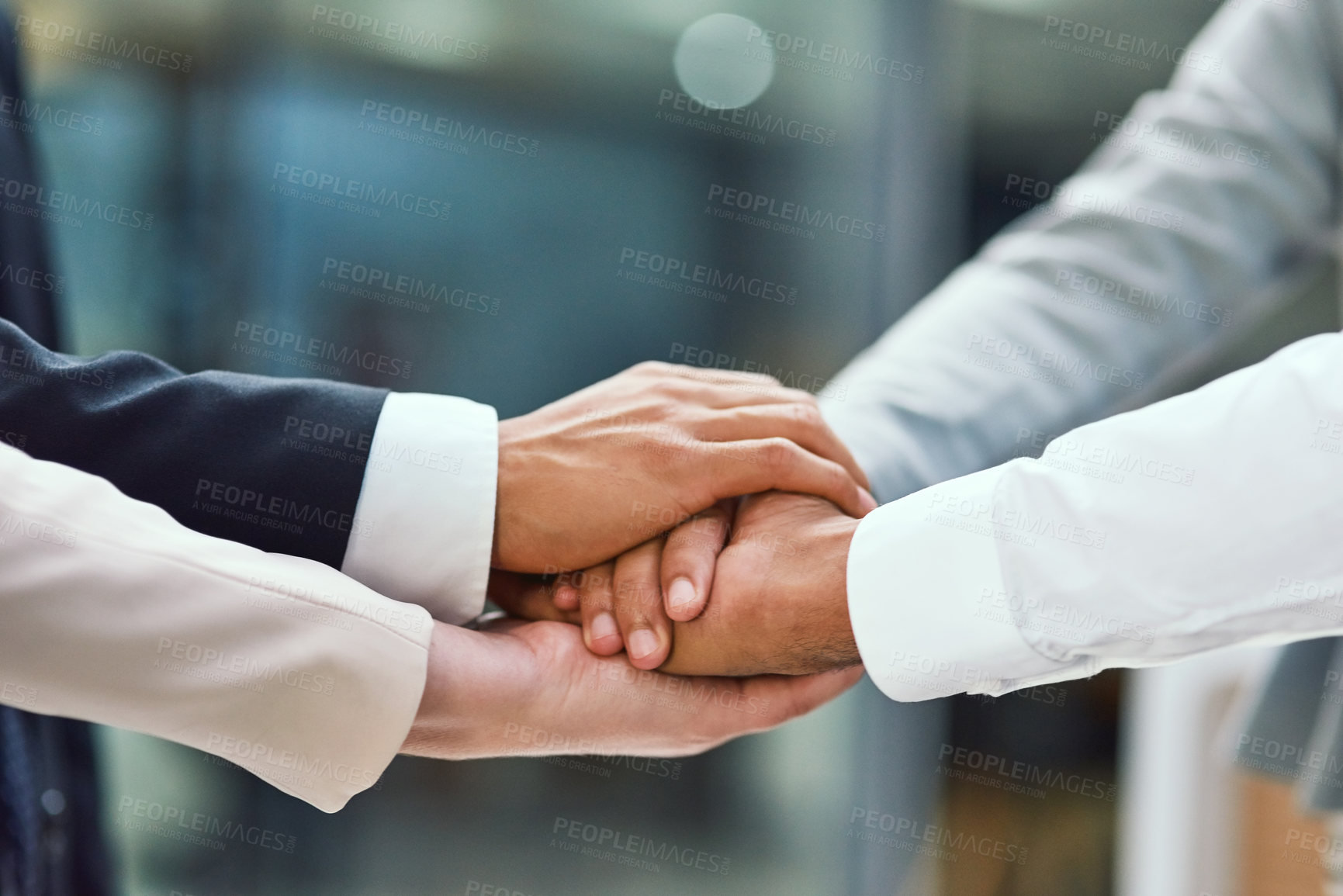 Buy stock photo Shot of a group of unrecognisable businesspeople joining their hands together in unity