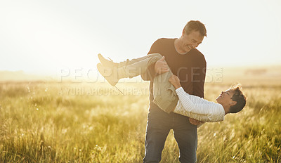 Buy stock photo Shot of a father and son having a good time outdoors