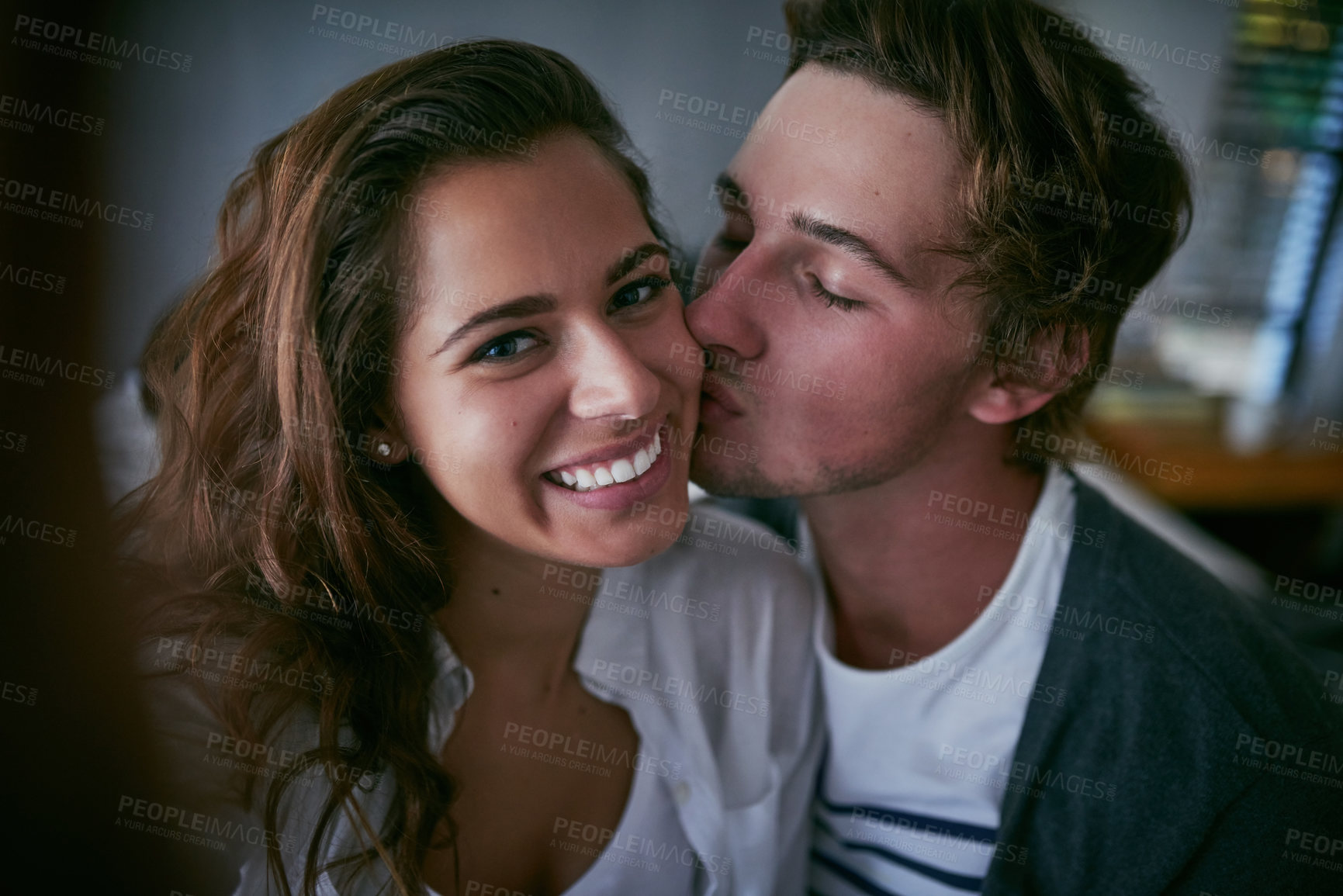 Buy stock photo Cropped shot of a loving young couple spending the day together at home