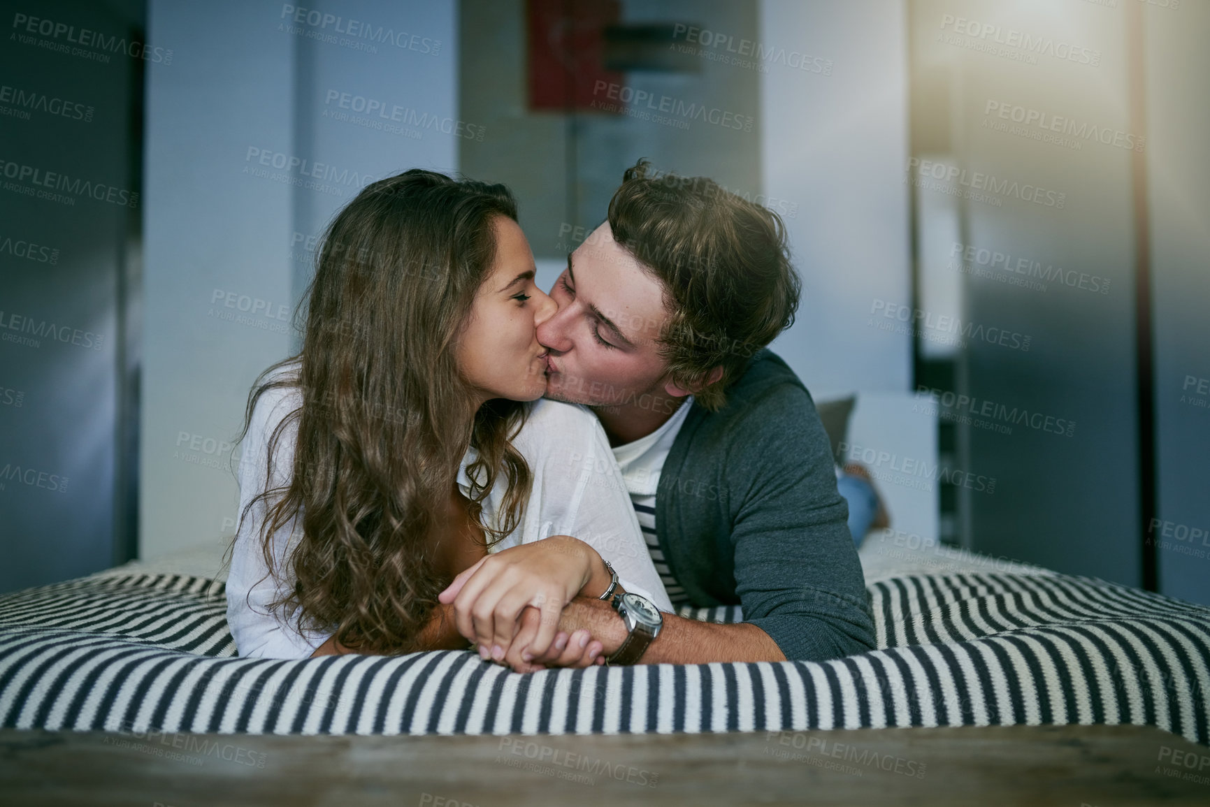 Buy stock photo Bedroom, kissing and couple with love, relax and morning with kindness, trust and bonding together. Home, embrace and man with woman, dating and care with romance, hug and marriage with relationship