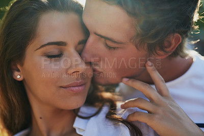 Buy stock photo Shot of an affectionate young couple bonding outdoors
