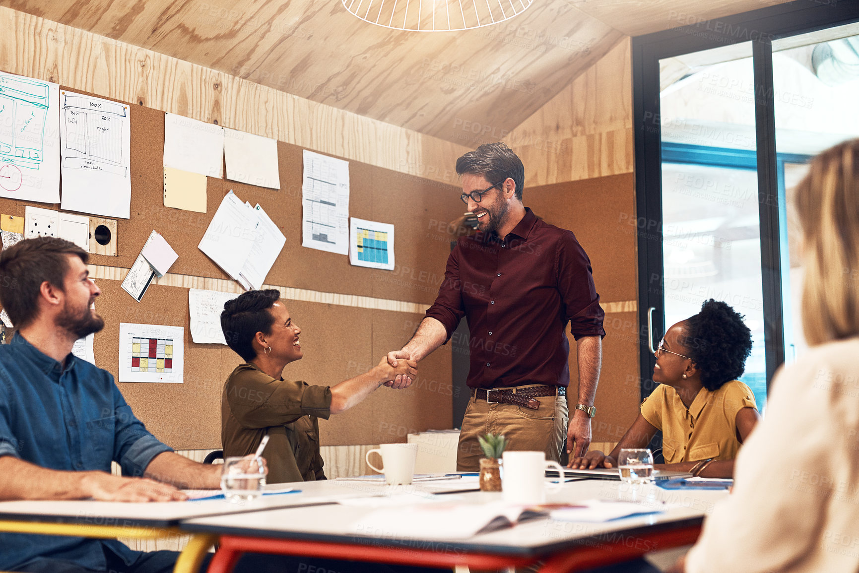 Buy stock photo Boardroom, business people and handshake in meeting for welcome, introduction or onboarding with smile. Office, employees or manager of marketing agency with team for shaking hands, deal or thank you