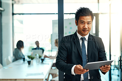 Buy stock photo Portrait of a confident businessman using a digital tablet in an office