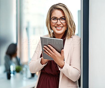 Buy stock photo Portrait of a confident businesswoman using a digital tablet in an office
