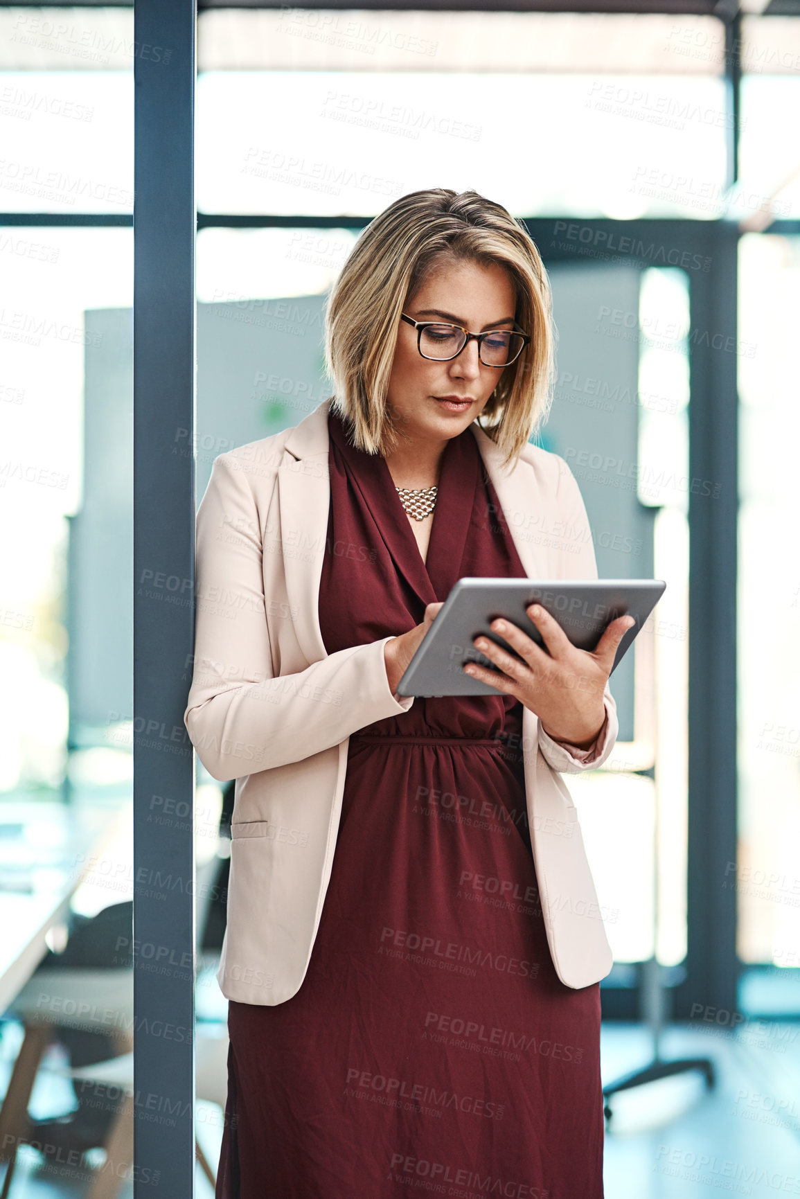 Buy stock photo Shot of a businesswoman using a digital tablet in an office