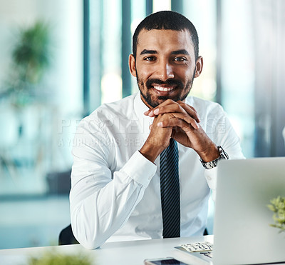 Buy stock photo Portrait of a confident businessman working on a laptop in an office