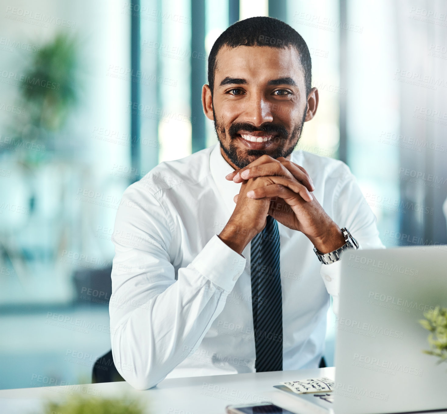 Buy stock photo Portrait of a confident businessman working on a laptop in an office