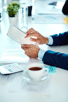 Buy stock photo Shot of an unrecognisable businessman using a digital tablet in an office