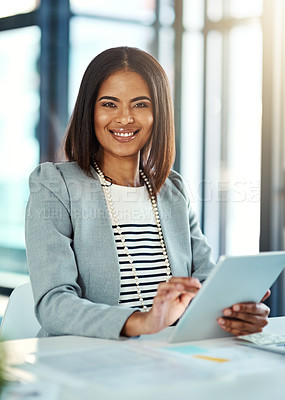 Buy stock photo Portrait of a confident businesswoman working on a digital tablet in an office