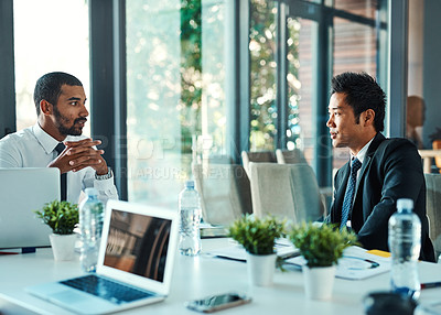 Buy stock photo Shot of two businessmen having a discussion in an office