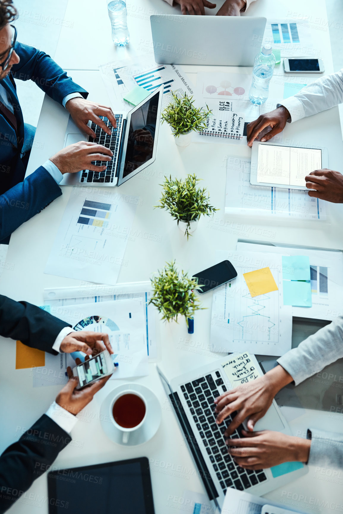 Buy stock photo High angle shot of unrecognisable businesspeople working in an office