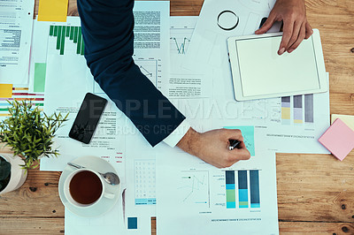 Buy stock photo High angle shot of an unidentifiable businessman working in an office