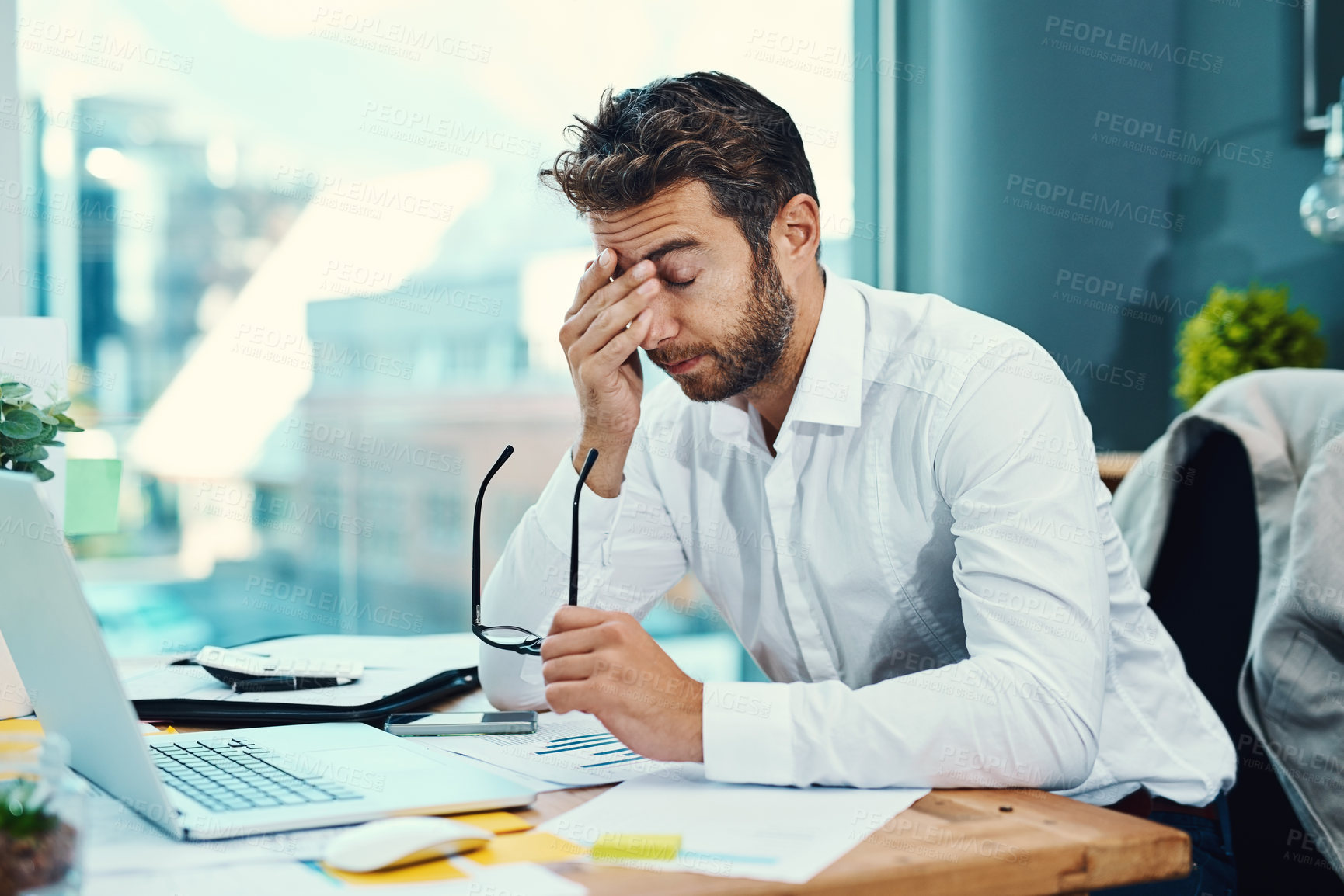 Buy stock photo Stress, anxiety and businessman with headache by laptop for pain, brain fog and fatigue in finance job. Accounting, agency and person with glasses by technology for audit, report or financial mistake