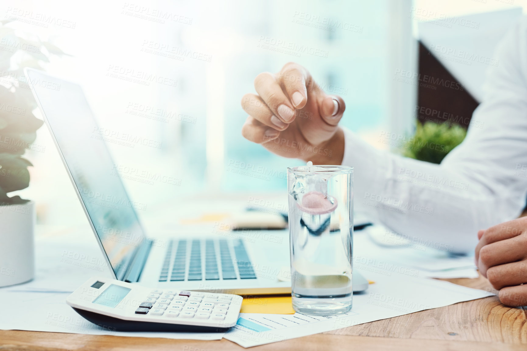 Buy stock photo Businessperson, hands and drop with pill in water for dosage, medication or healthcare remedy at office. Closeup of employee or glass of mineral liquid for pharmaceutical or medical cure at workplace