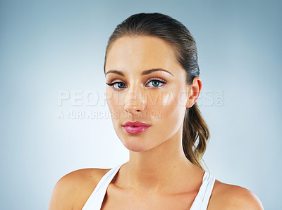 Buy stock photo Studio shot of a beautiful and healthy young woman against a blue background