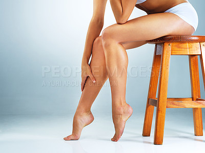Buy stock photo Studio shot of an unrecognizable woman's legs against a blue background