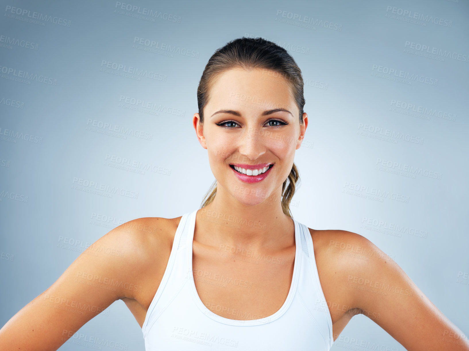 Buy stock photo Woman, face and smile with confidence for fitness, health and wellness in studio on blue background. Female person, portrait and confident model with happiness for wellbeing, vitality or self care