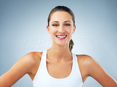 Buy stock photo Woman, wellness and smile with confidence for fitness, health and portrait in studio on blue background. Female person, face and confident model with happiness for wellbeing, vitality or self care