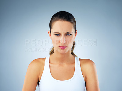 Buy stock photo Fitness, frown and woman in studio for portrait, doubt and disbelief for story or gossip. Female person, healthy body and grudge on blue background for rumor, bad news and opinion on training update