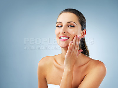 Buy stock photo Studio shot of a beautiful and healthy young woman against a blue background