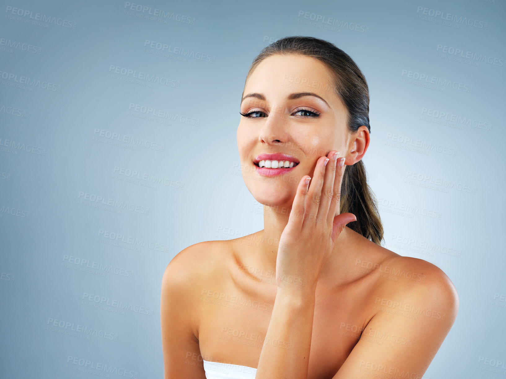 Buy stock photo Studio shot of a beautiful and healthy young woman against a blue background