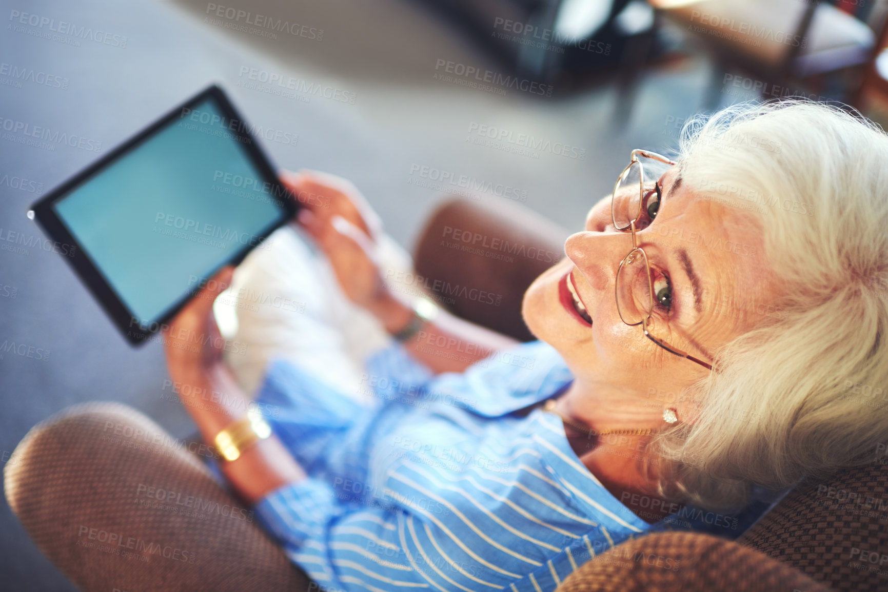 Buy stock photo Senior woman, smile and tablet on sofa for streaming, internet and video call in home living room. Elderly person, portrait and tech on couch with helping hand for social media, app or communication