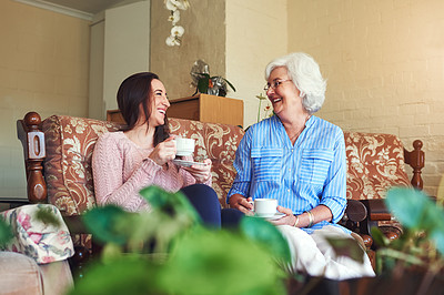 Buy stock photo Cropped shot of a senior woman and her granddaughter drinking a cup of tea at home