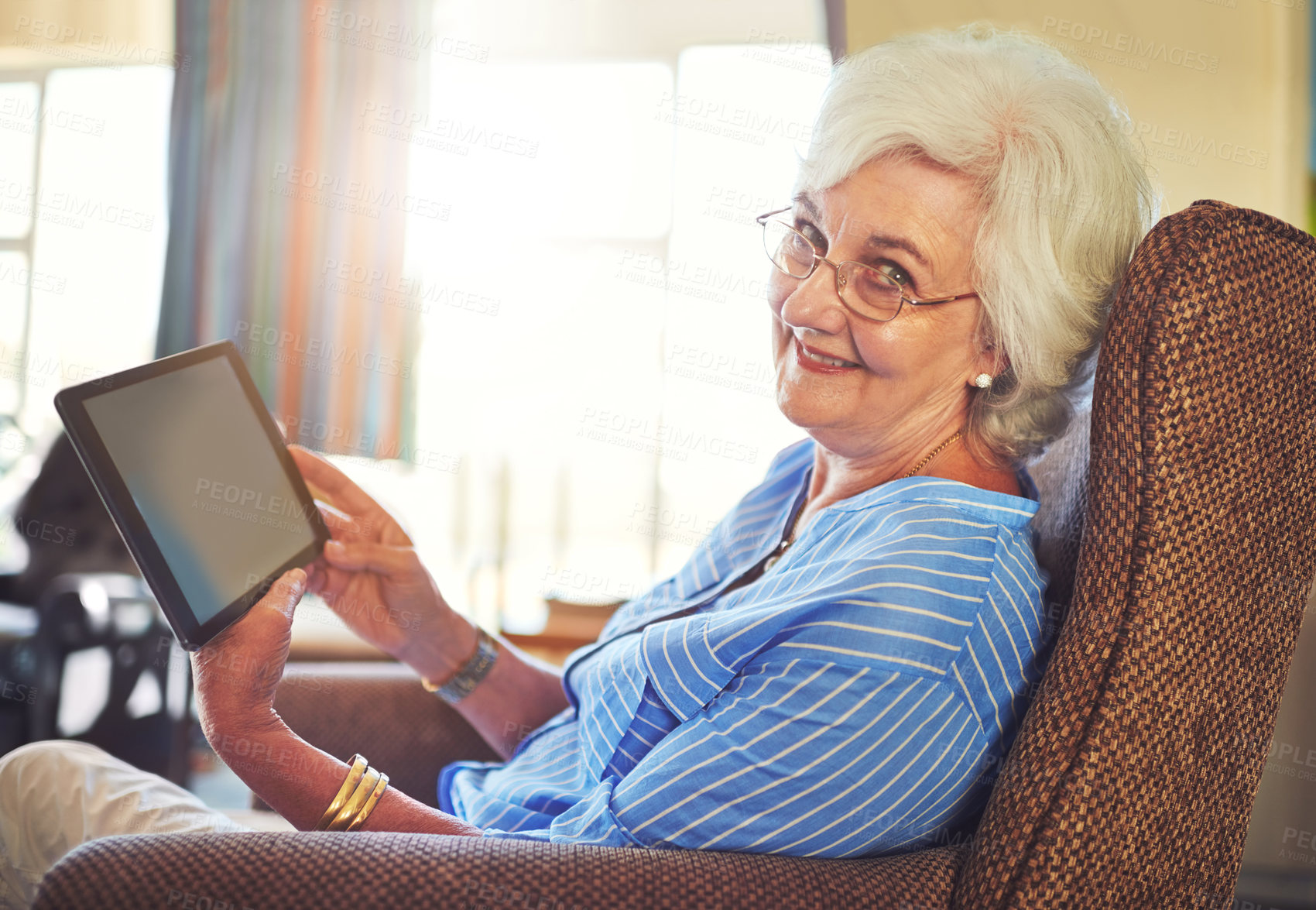 Buy stock photo Senior woman, portrait and tablet on couch for streaming, internet and video call in home living room. Elderly person, smile and tech on sofa with helping hand for social media, app or communication