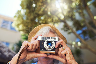 Buy stock photo Cropped shot of a senior woman taking photographs at home