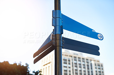 Buy stock photo Sign, street and travel direction in city, blank display and public information for tourism. Arrow, crossroads and guide for navigation to destination in town, advice pole and urban space mockup