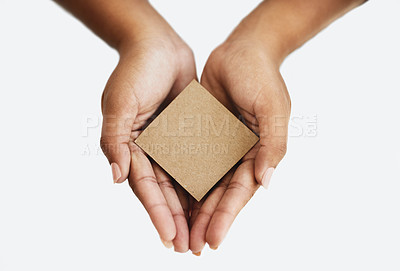 Buy stock photo Closeup of the hands of a person showing a message, advertising a product or holding an empty paper or a cardboard card against a white background. Top view of woman promoting an item or sign