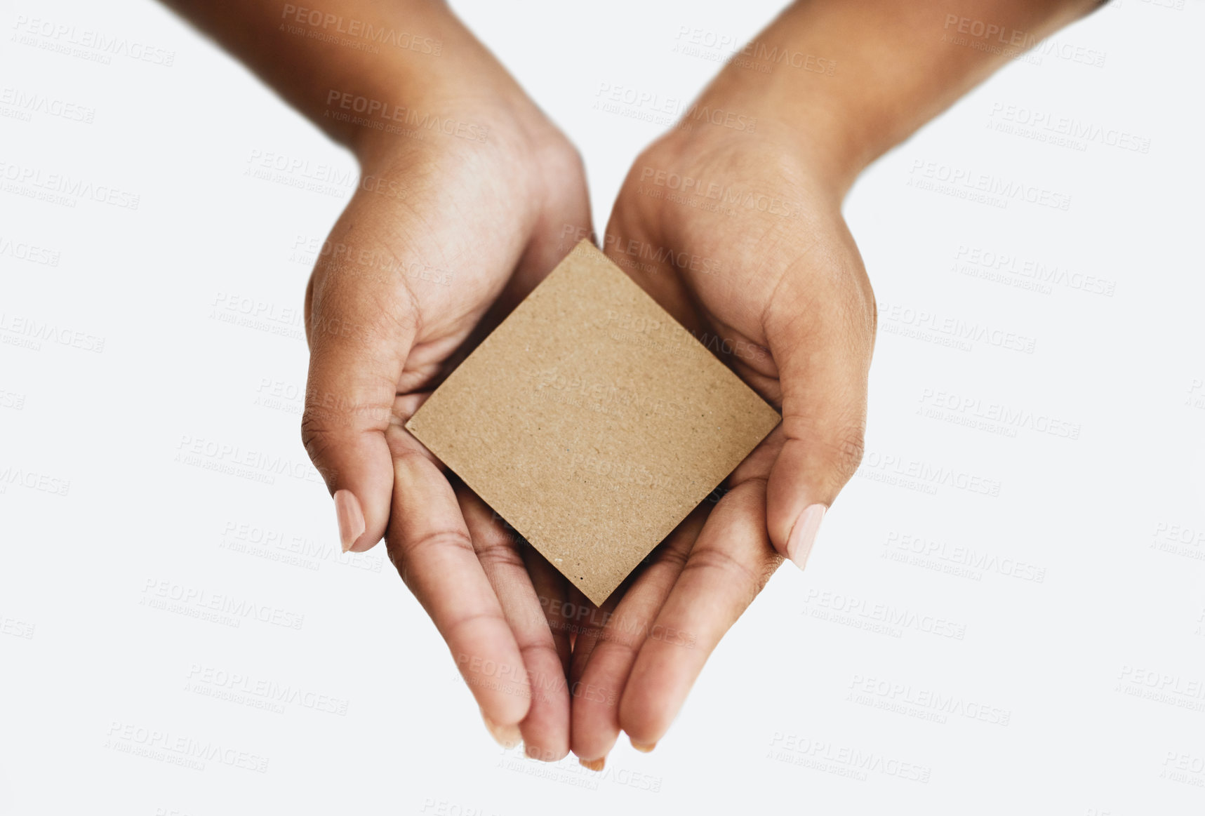 Buy stock photo Closeup of the hands of a person showing a message, advertising a product or holding an empty paper or a cardboard card against a white background. Top view of woman promoting an item or sign