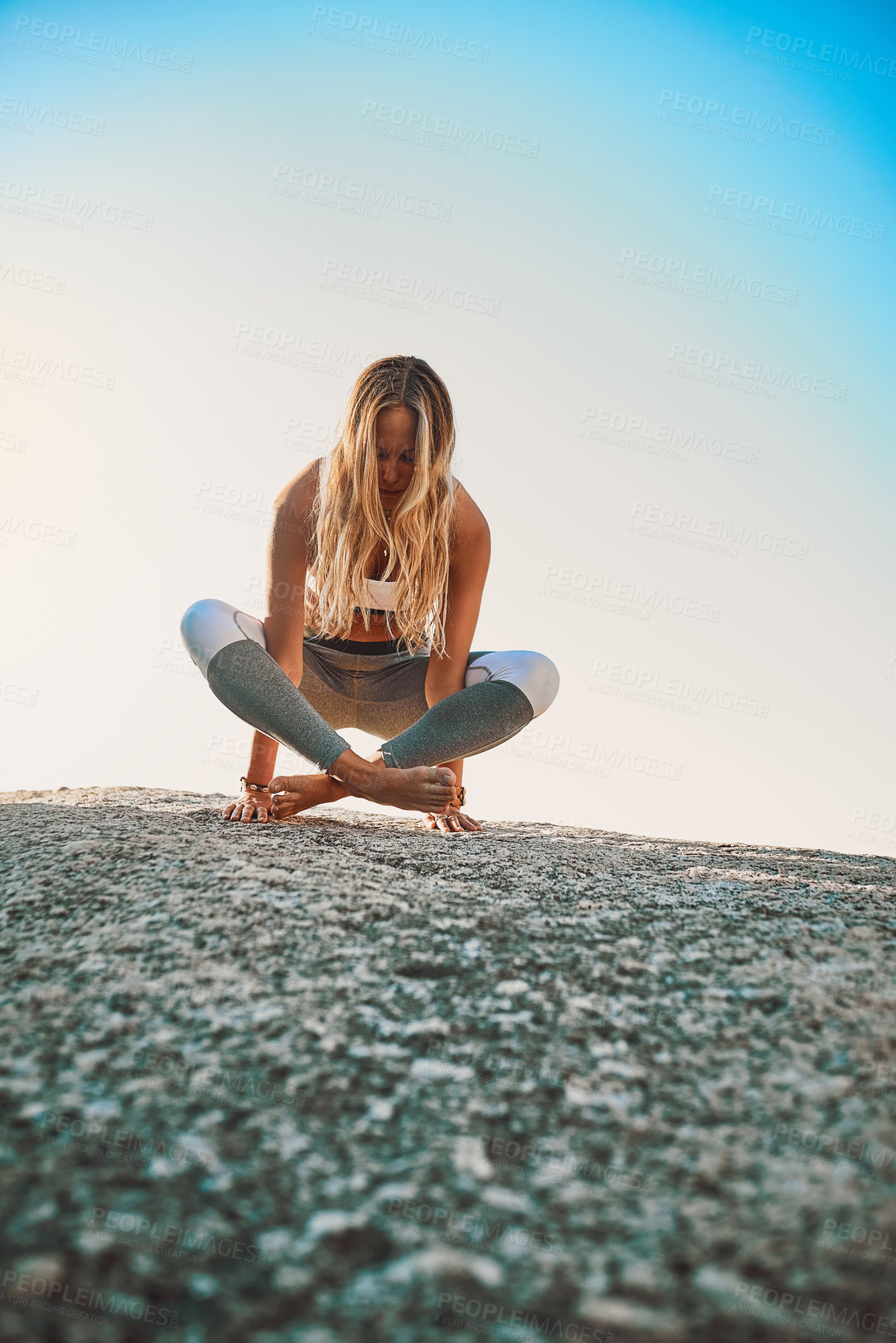 Buy stock photo Shot of an athletic young woman practicing yoga on the beach