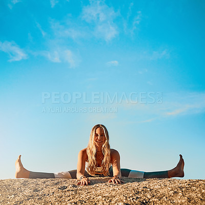 Buy stock photo Shot of an athletic young woman practicing yoga on the beach