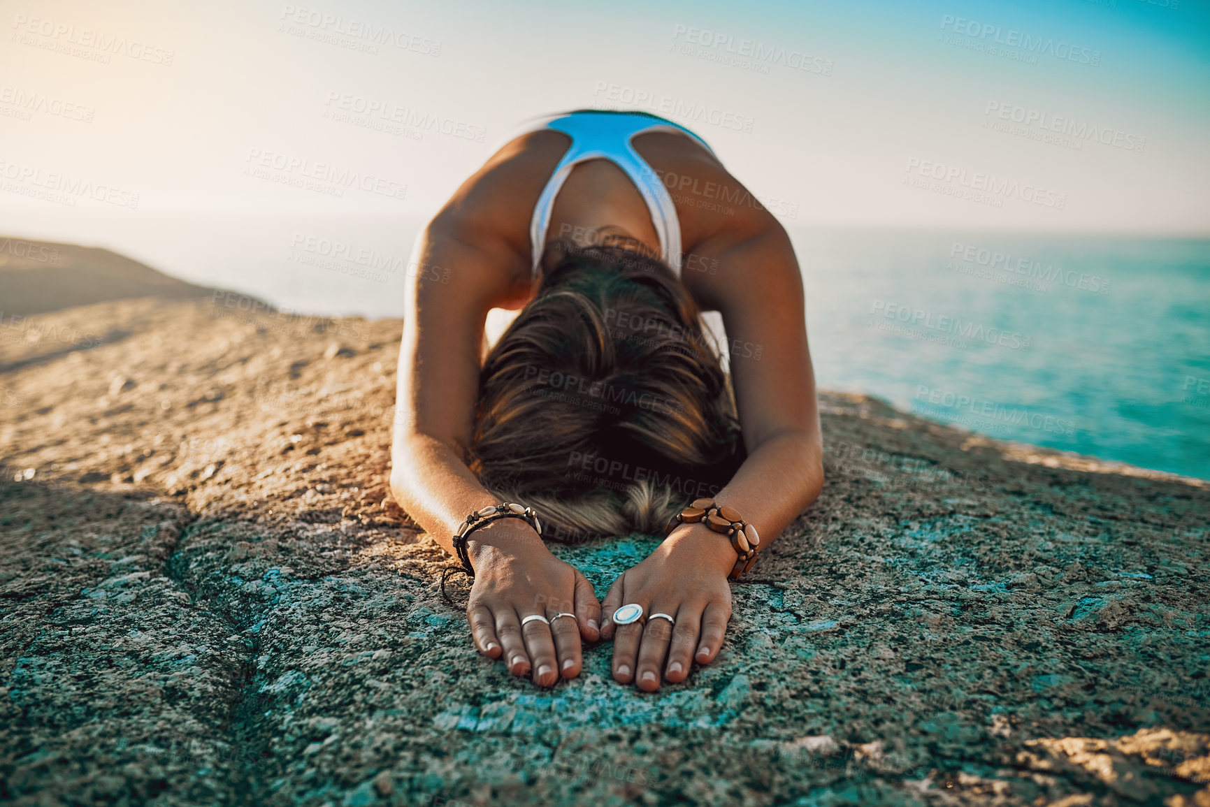 Buy stock photo Shot of a woman practising the child pose at then beach