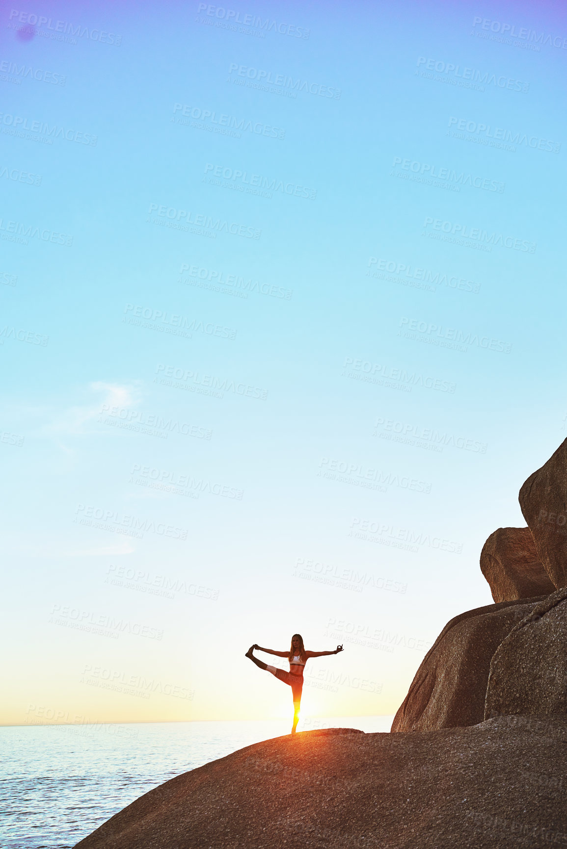 Buy stock photo Shot of an athletic young woman practicing yoga on the beach