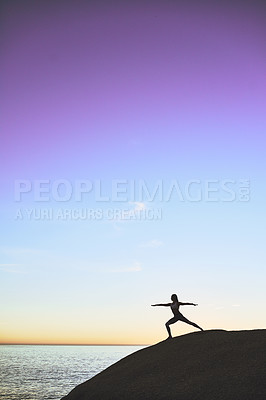 Buy stock photo Woman, silhouette and beach with yoga on rock for fitness, holistic or outdoor exercise in nature. Female person or yogi in warrior pose, zen or health and wellness with blue sky or space by ocean