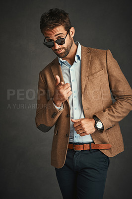 Buy stock photo Portrait, fashion and man with sunglasses, studio and stylish with jacket, proud and business casual. Corporate, entrepreneur and trendy with clothes, smile and professional  model in gray background