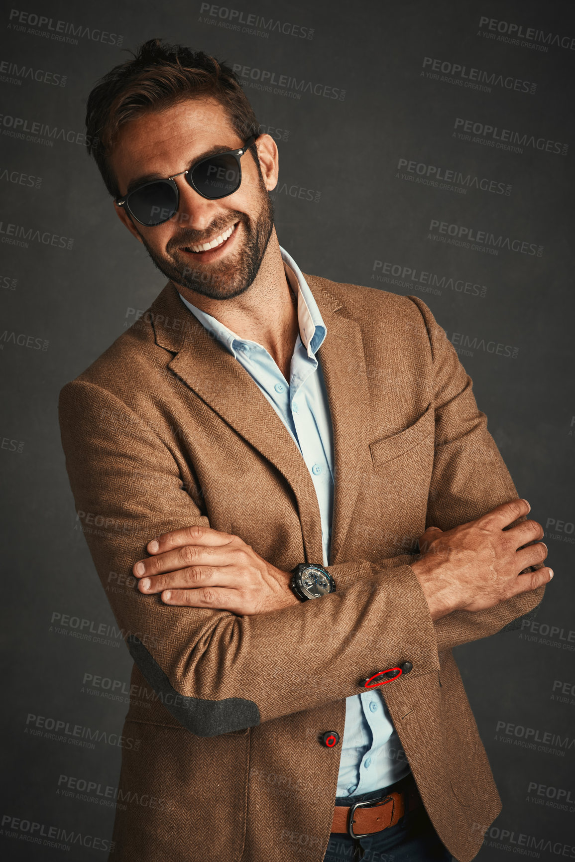 Buy stock photo Studio shot of a handsome young man posing against a gray background